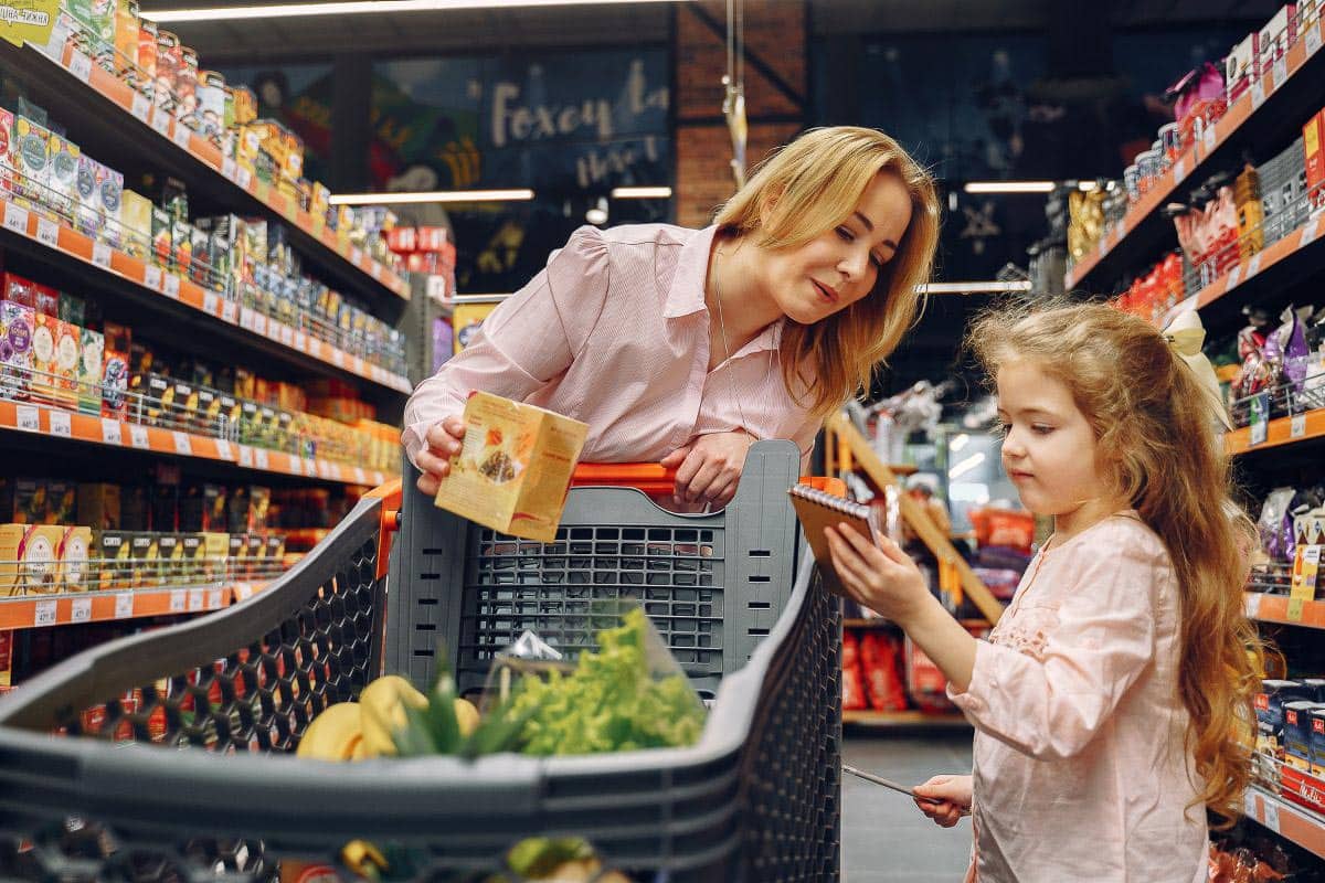 mom and daughter in supermarket.