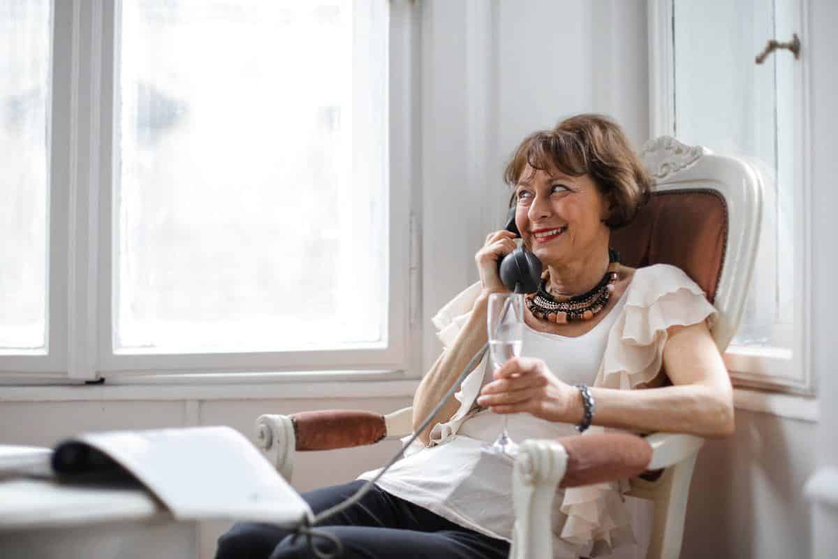 older woman making phone call.
