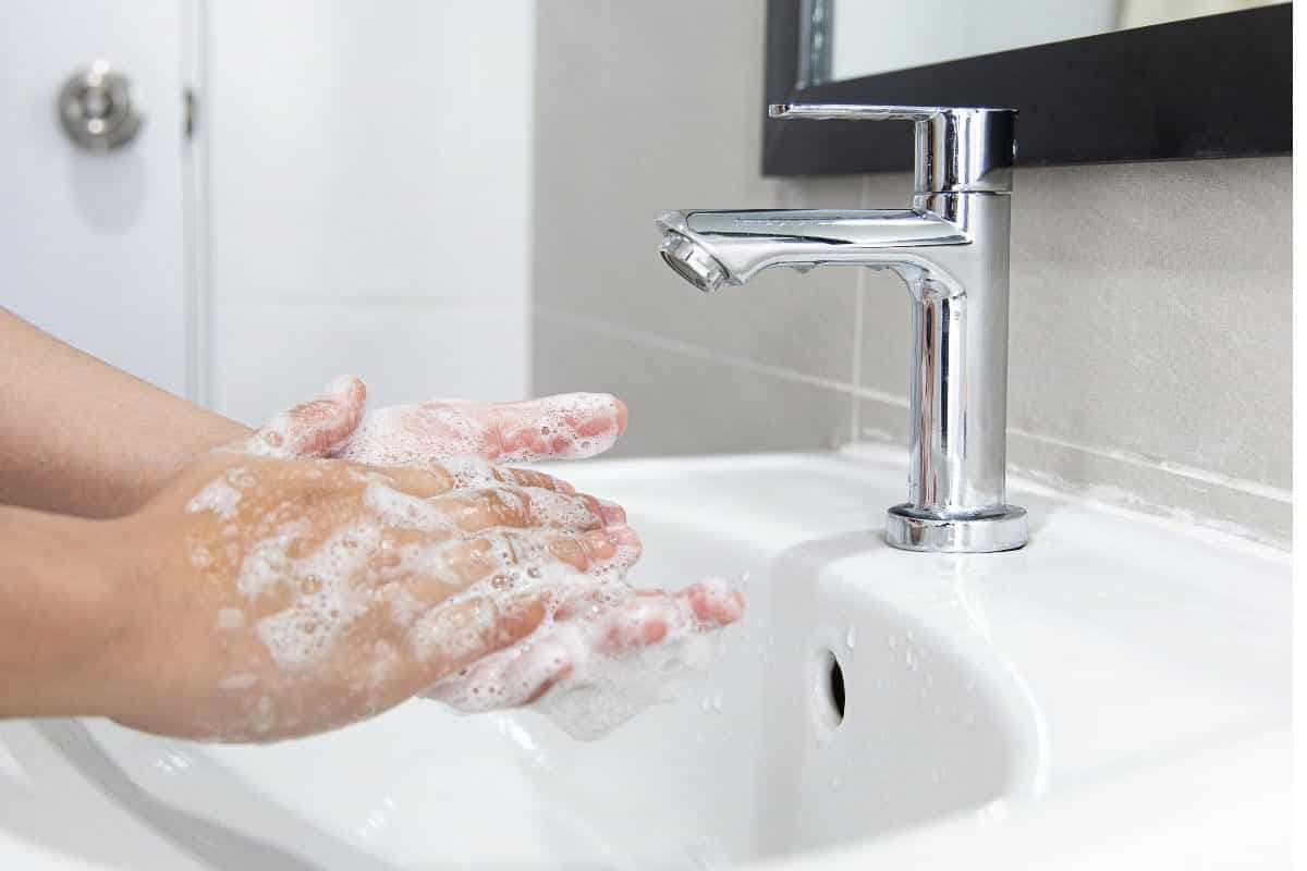 person thoroughly hand washing.