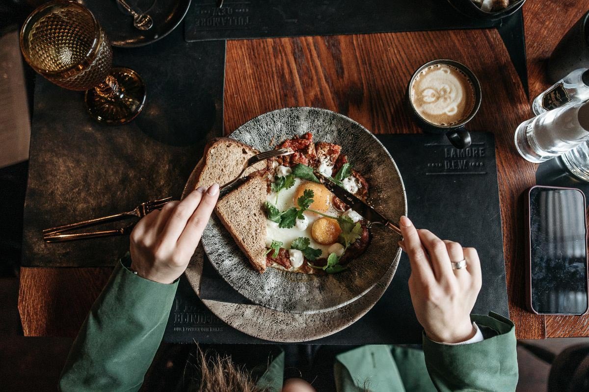 woman eating breakfast.
