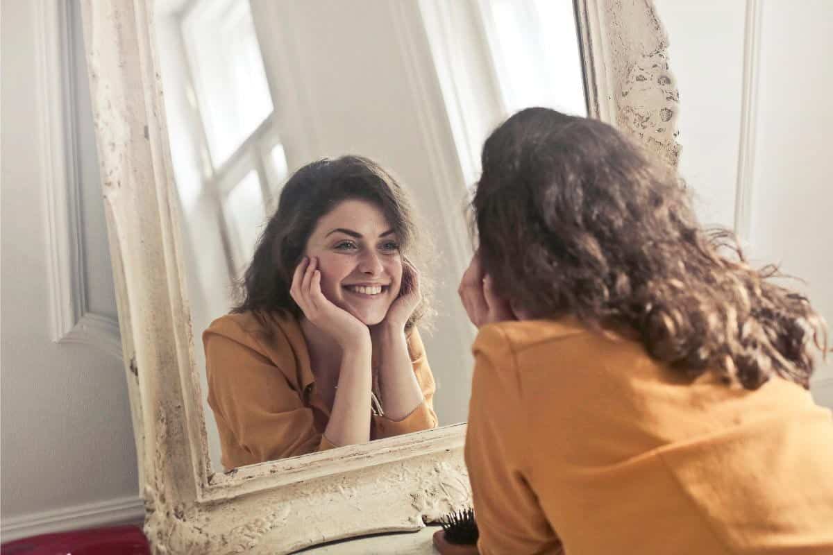woman gazing in mirror.