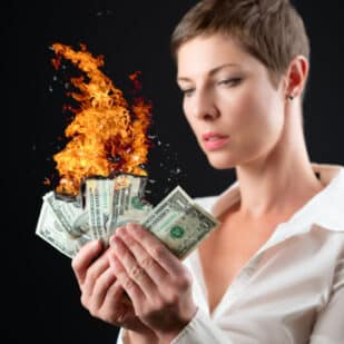 Short haired woman burning money.