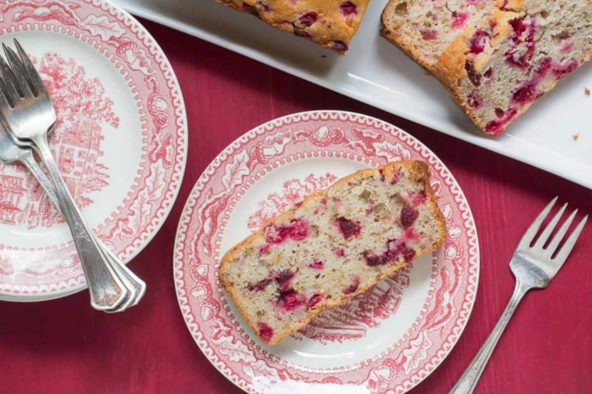 Low FODMAP Cranberry Orange quick bread on pink and white plate.