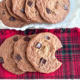 Low FODMAP Gingerbread Chocolate Chunk Cookies on tartan napkin.
