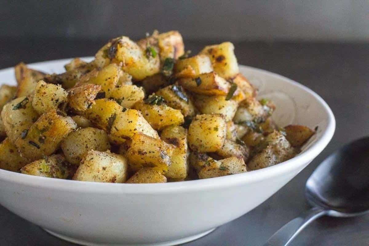 Low FODMAP home fries in white bowl.