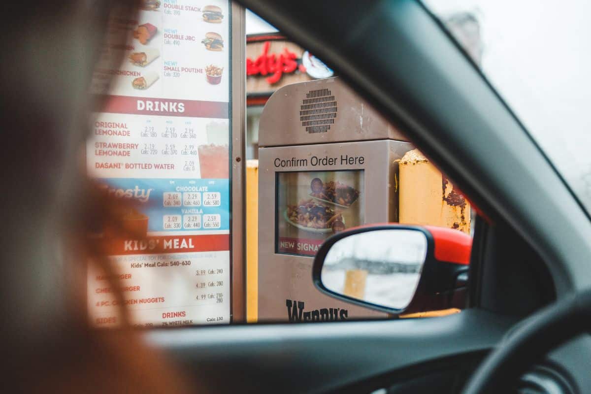 Person ordering fast food in drive thru Photo Credit_ Erik Mclean from Pexels via Canva
