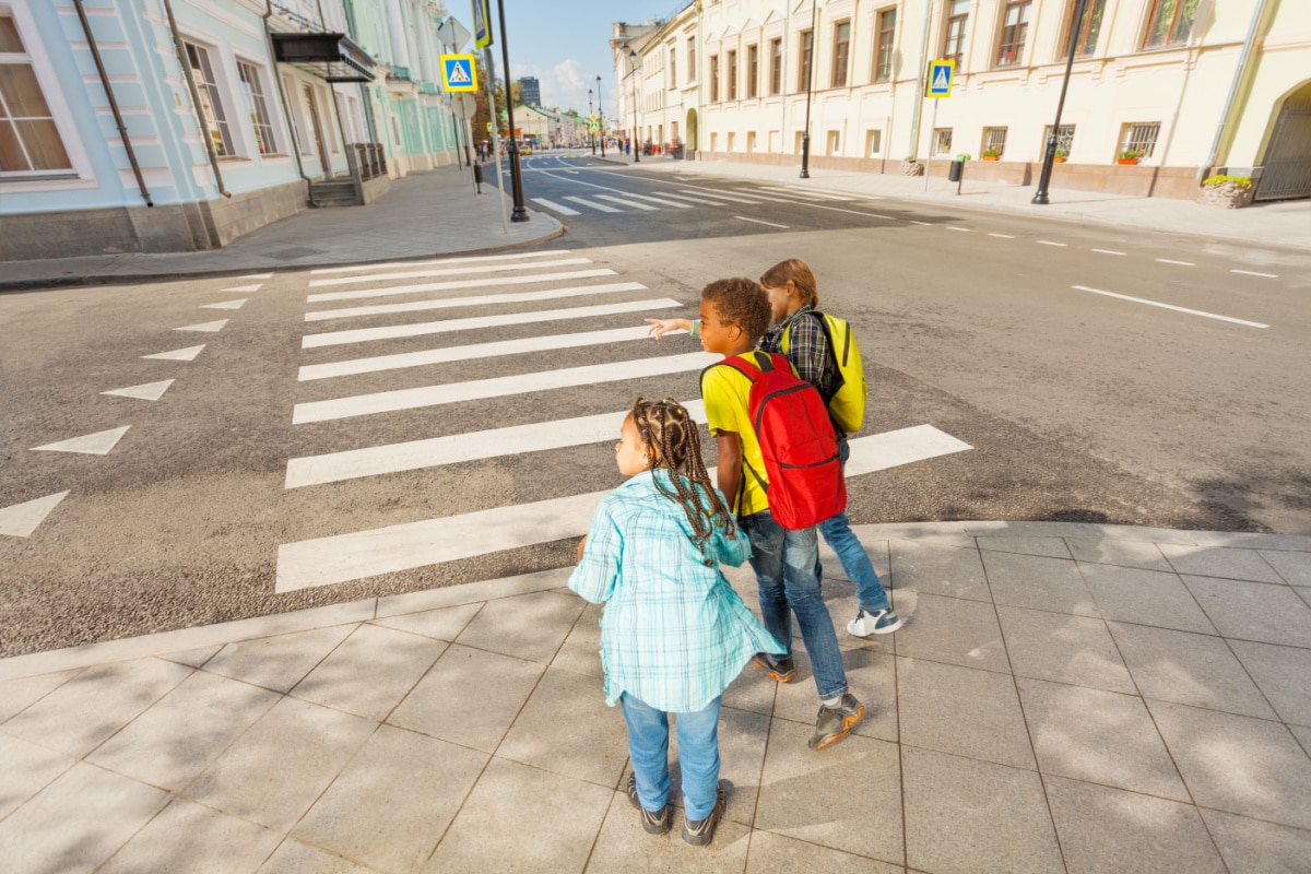 Careful children crossing street.