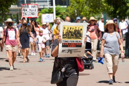 Oakland, CA - June 11 2022, Unidentified participants in March for our Lives marching around Frank H Ogawa Plaza holding signs demanding action against gun violence.