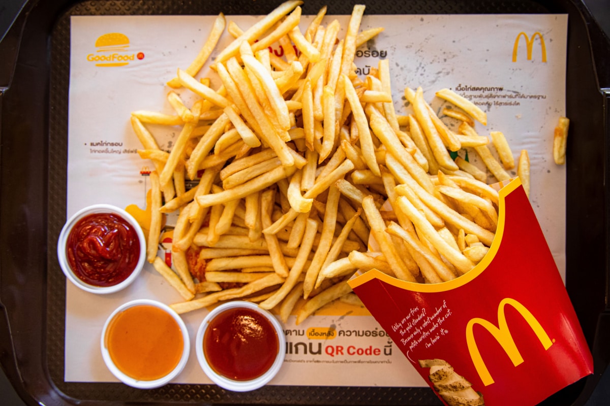 Top View of McDonald's French fries XXL Size with tomato sauce ,chili sauce and American ketchup sauce in McDonald's Restaurant.
