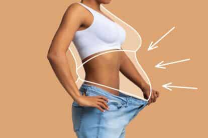 Thin woman in large jeans. Shutterstock_2270507665.