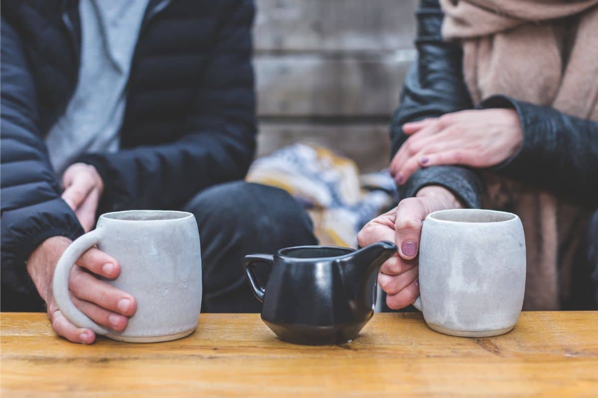 Two people sharing hot beverage.