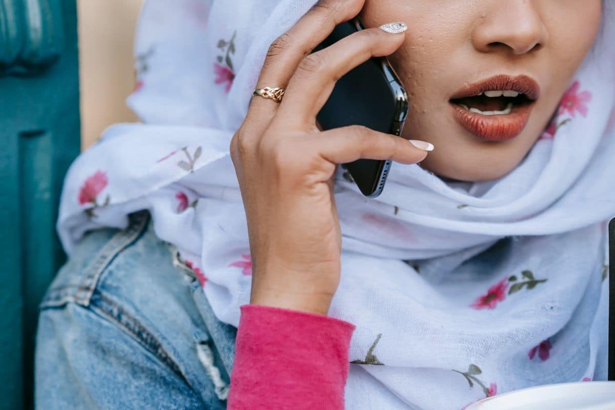 Woman in headscarf talking on phone. 