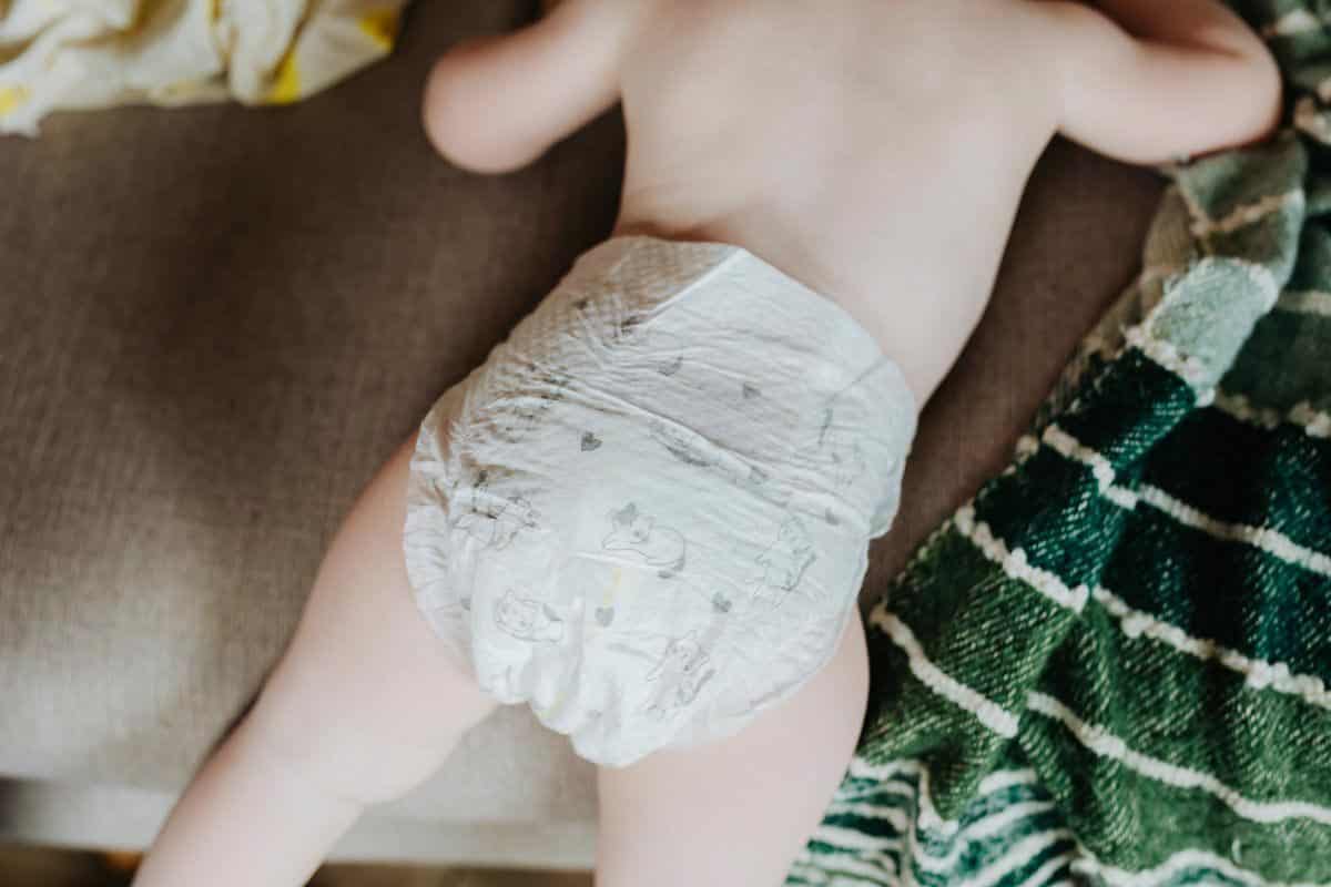 baby in diapers, face down. 
