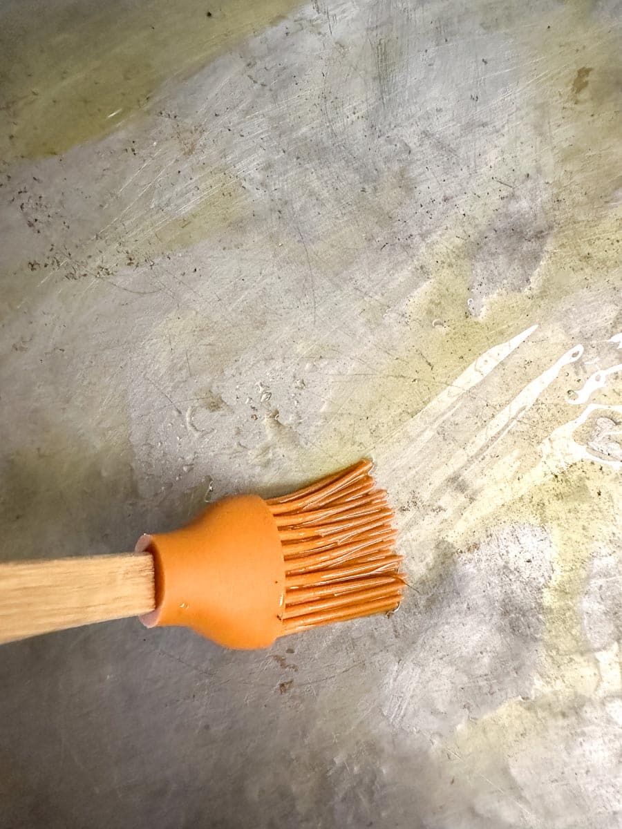 brushing sheet pan with oil.