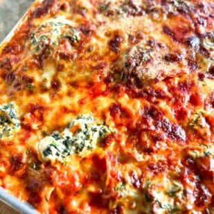 closeup of Baked low FODMAP Sheet Pan Lasagna with sausage on pan.