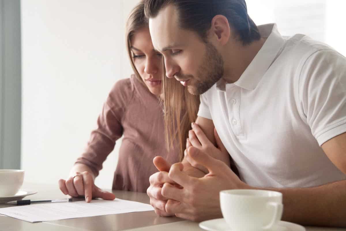 couple looking at paperwork. Shutterstock_626698901.