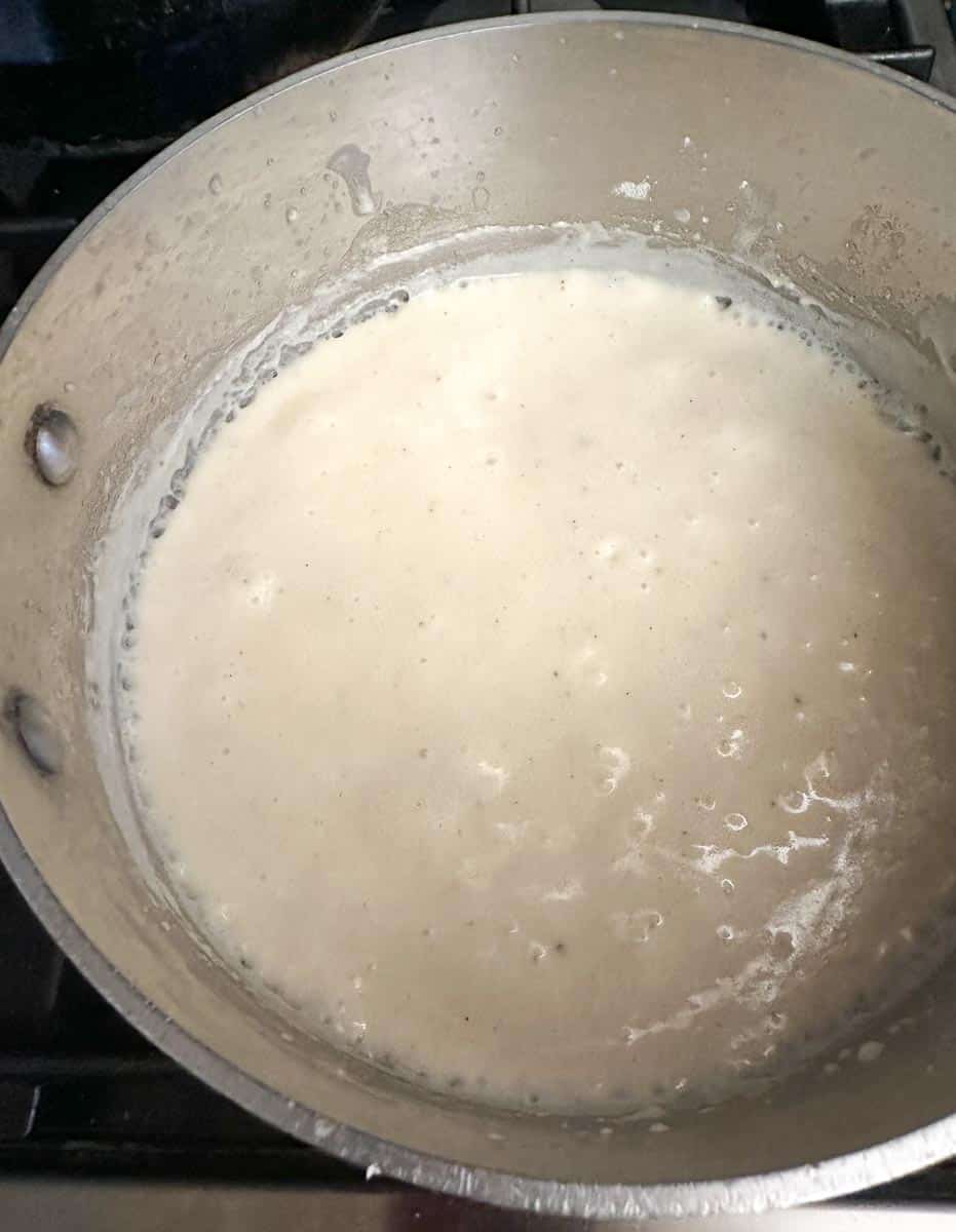 low FODMAP white gravy thickening in pot.