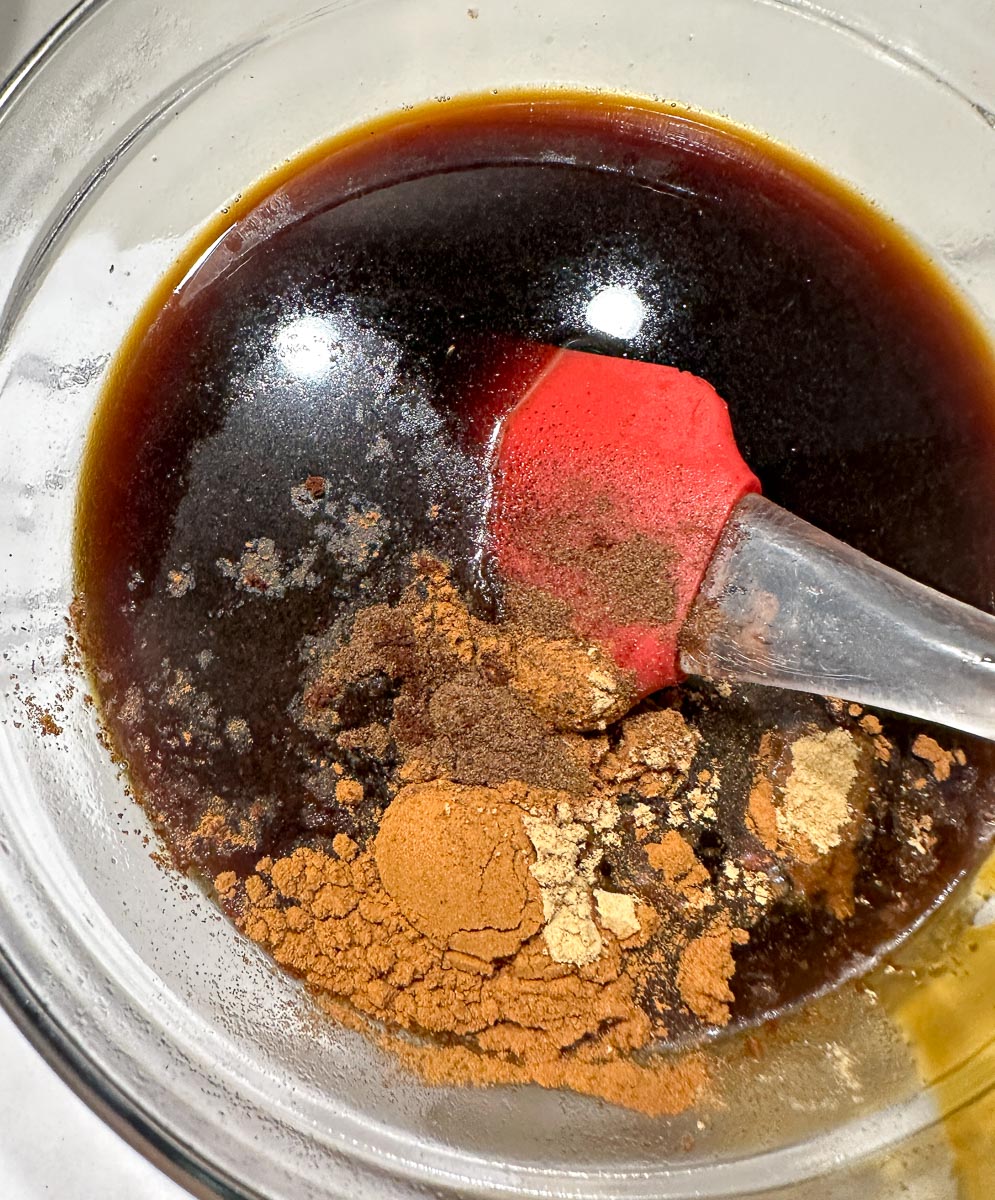 molasses, water and spices in glass bowl.