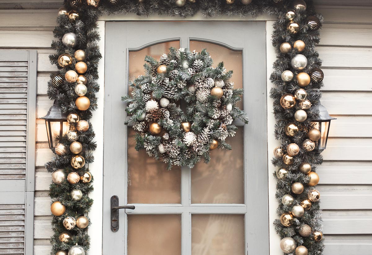 green wreath on door on porch.