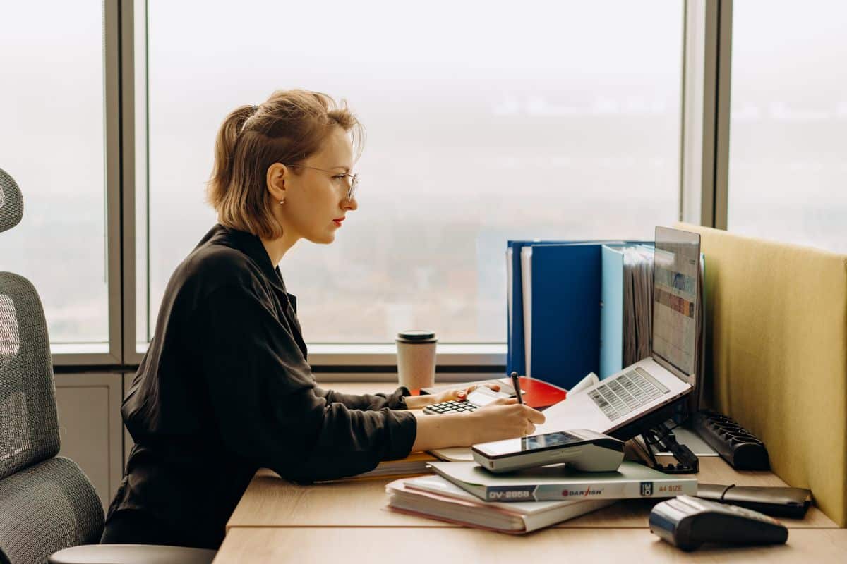 woman in glasses using computer.