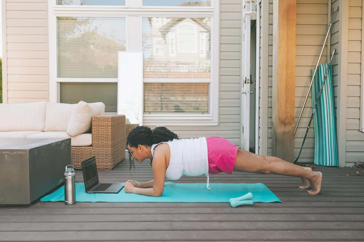 woman on deck holding a plank. 