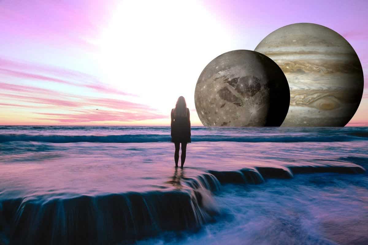 woman standing on water; planets in background.