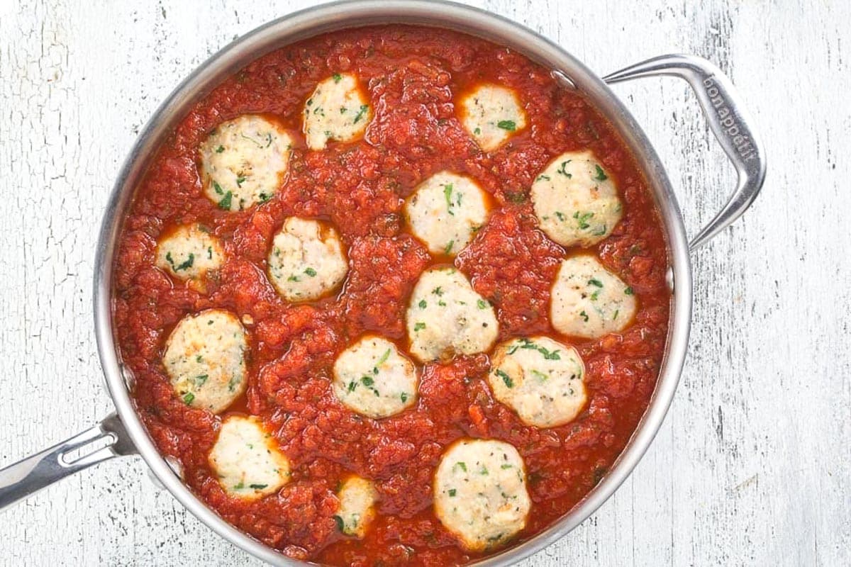 turkey-meatballs-in-tomato-sauce-in-a-saucepan-on-a-white-background.