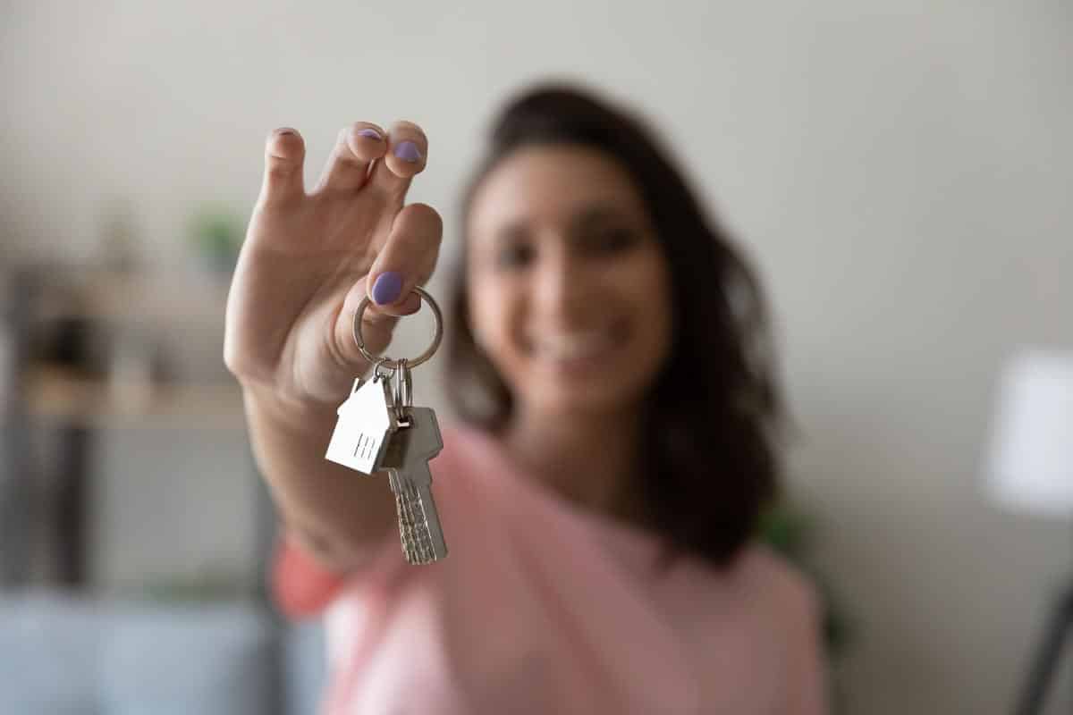 woman holding keys. Shutterstock_1800995116.