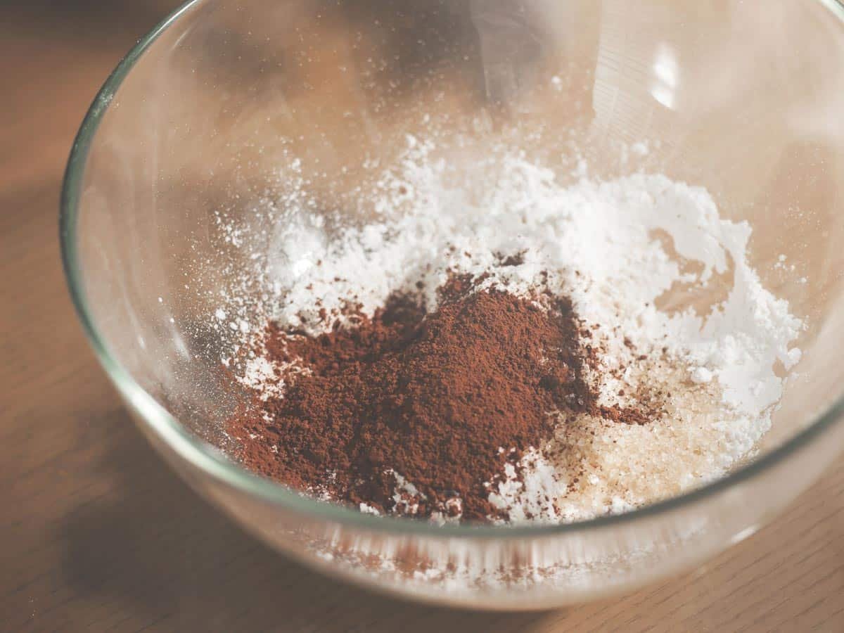 cocoa in glass bowl with other ingredients. Shutterstock_598759481.