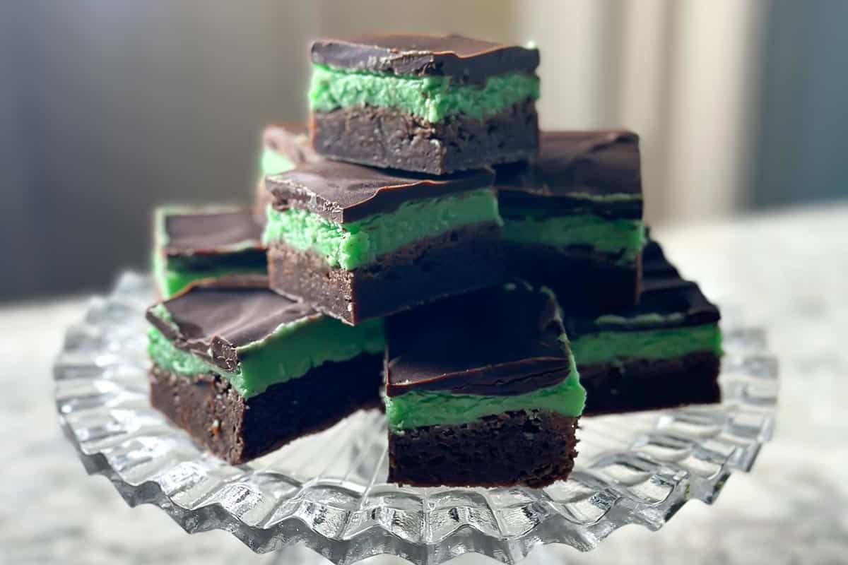 low FODMAP mint brownies cut into squares piled on glass pedestal 2.