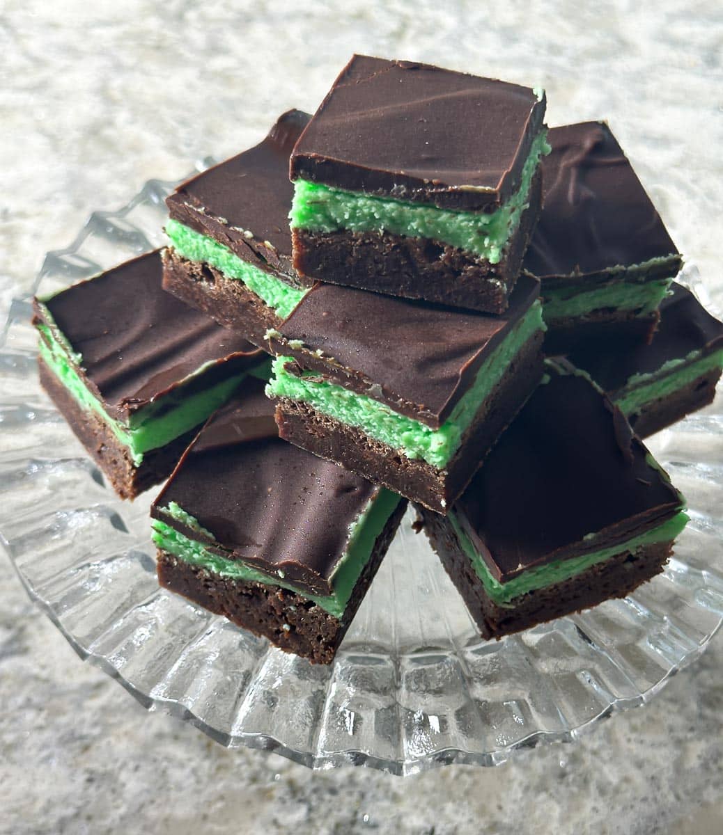 mint brownies on clear glass pedestal.