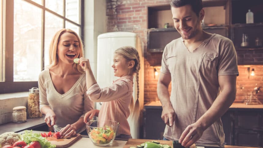 Happy family cooking and eating.
