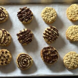 Low FODMAP Girl Scout Do-Si-Do Copycat cookies on tray, some with chocolate.
