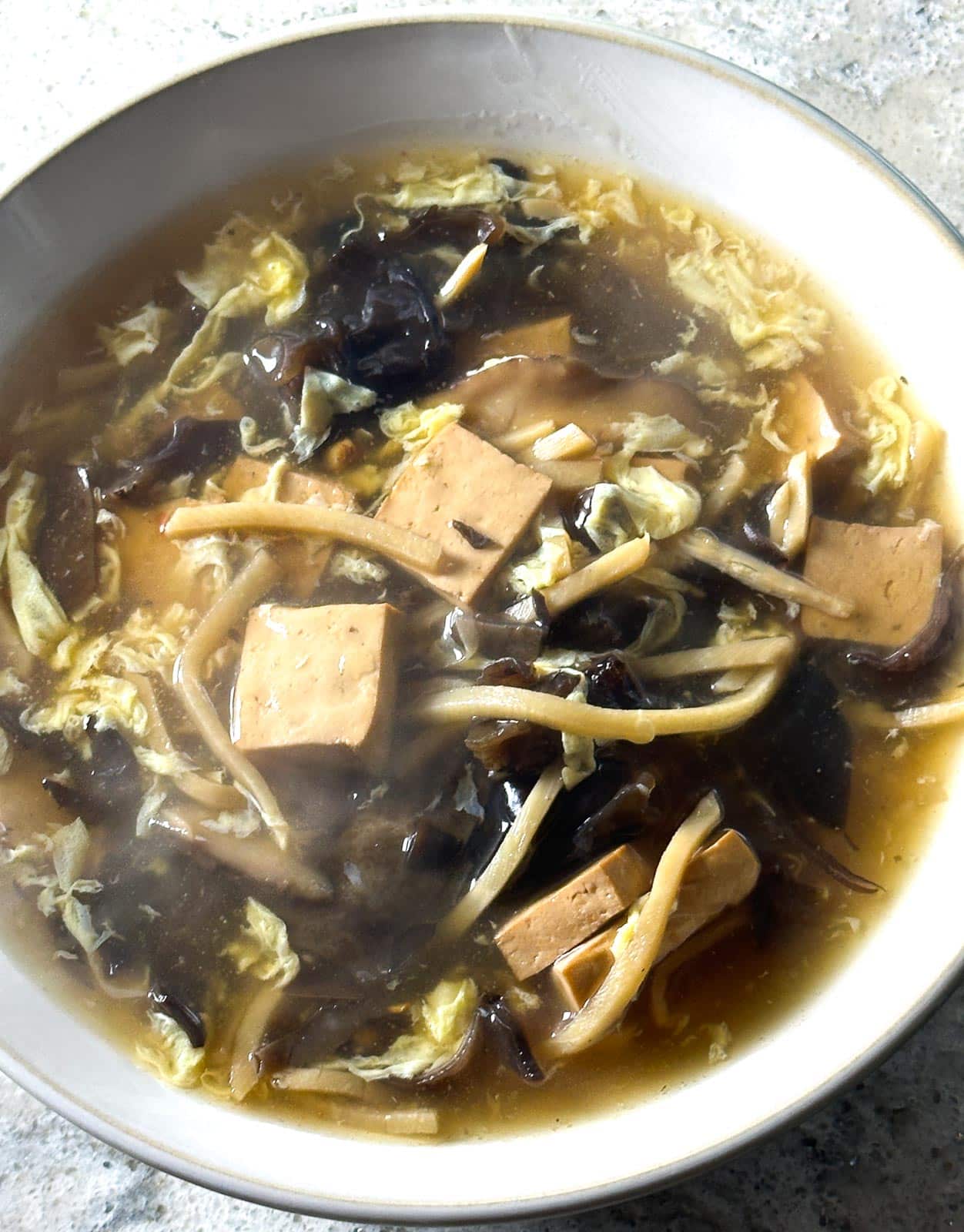 closeup of Low FODMAP Vegetarian Hot and Sour Soup on white bowl