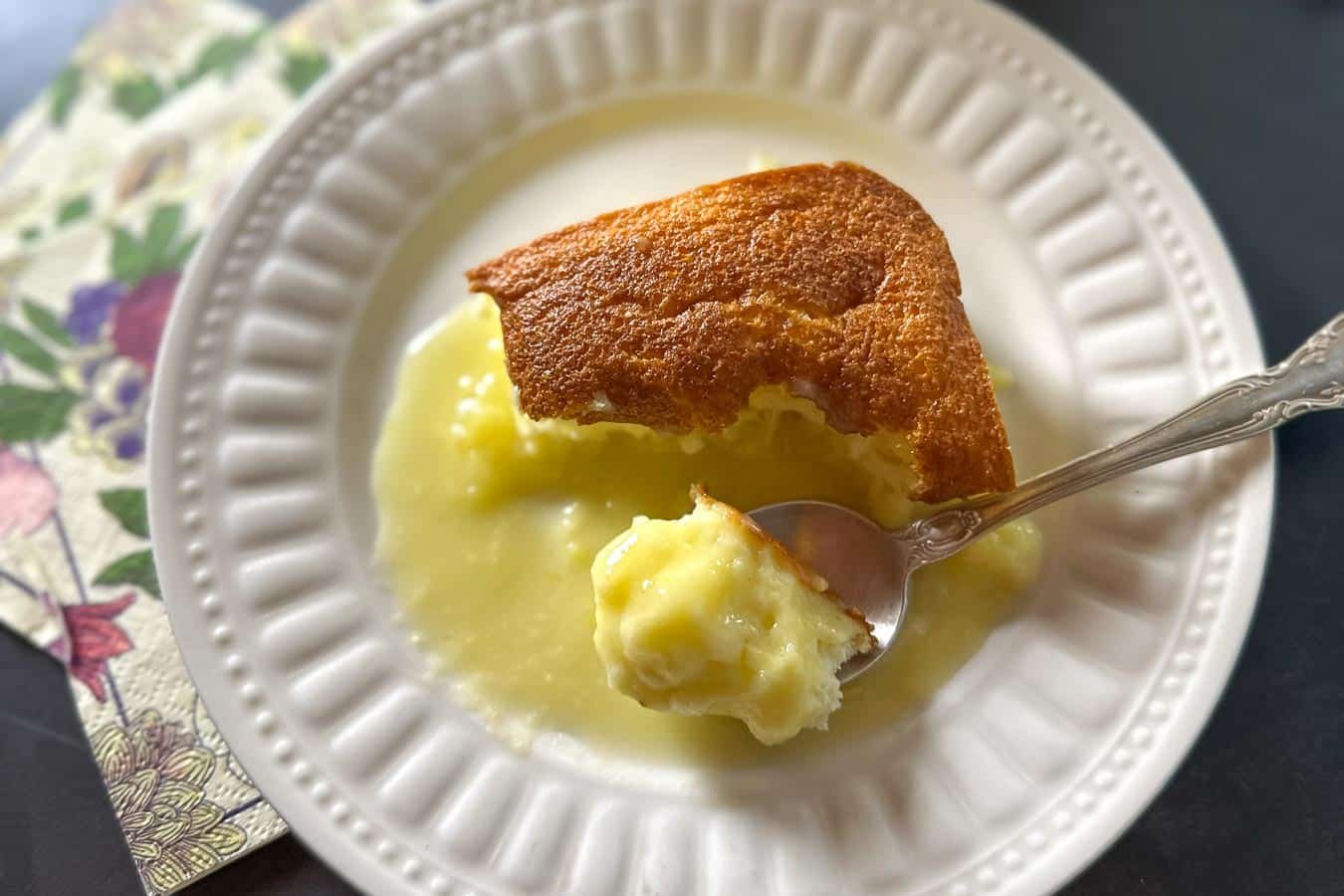 Low FODMAP Lemon Pudding Cake in pan and on plate. close.