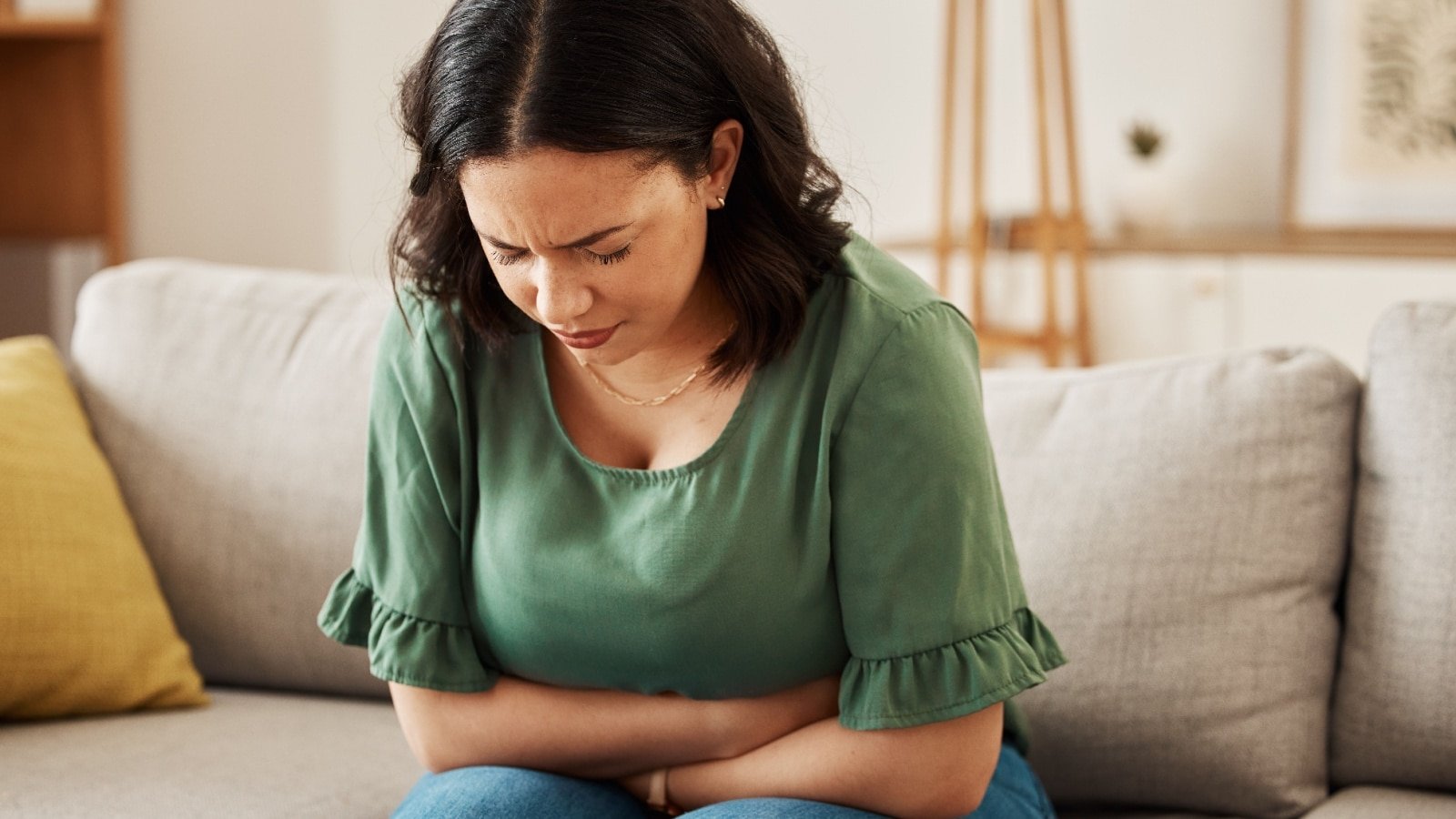 woman in pain clutching stomach. 