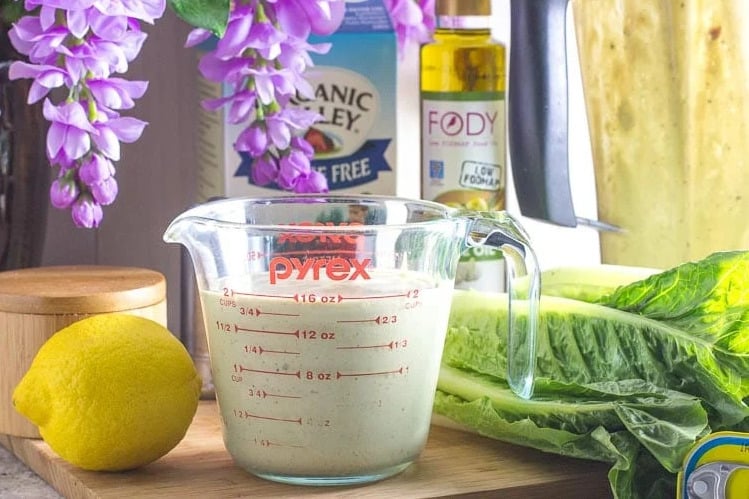 Caesar-salad-dressing-in-measuring-cup-with-ingredients-in-background-ezgif.com-crop.