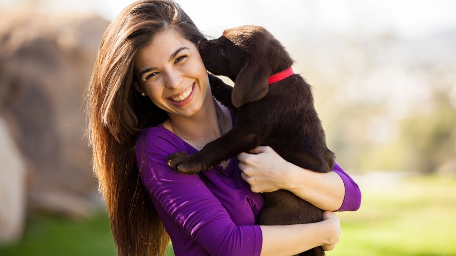 woman with Labrador puppy.