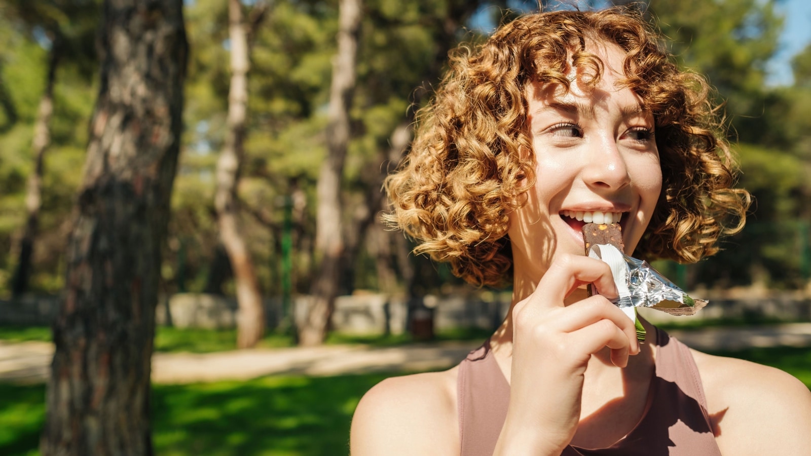 woman eating protein bar.