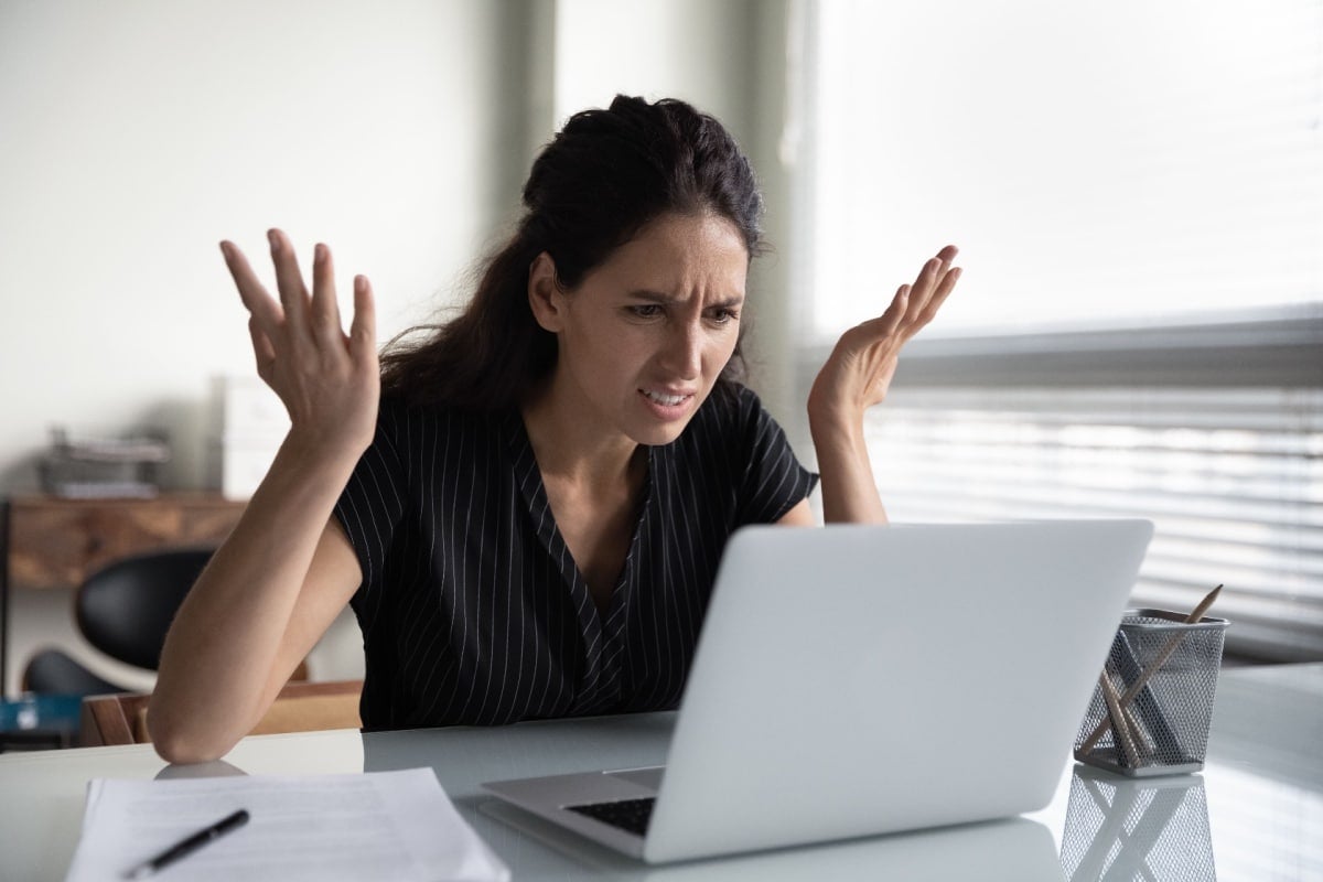 Angry surprised shocked woman looking at computer. 