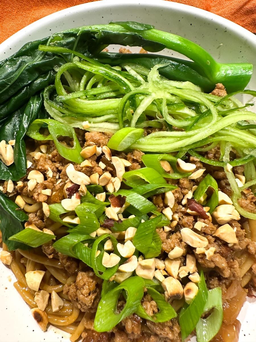 Low FODMAP Dan Dan Noodles in bowl closeup.