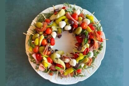 Low FODMAP Antipasto Wreath on dark teal background.