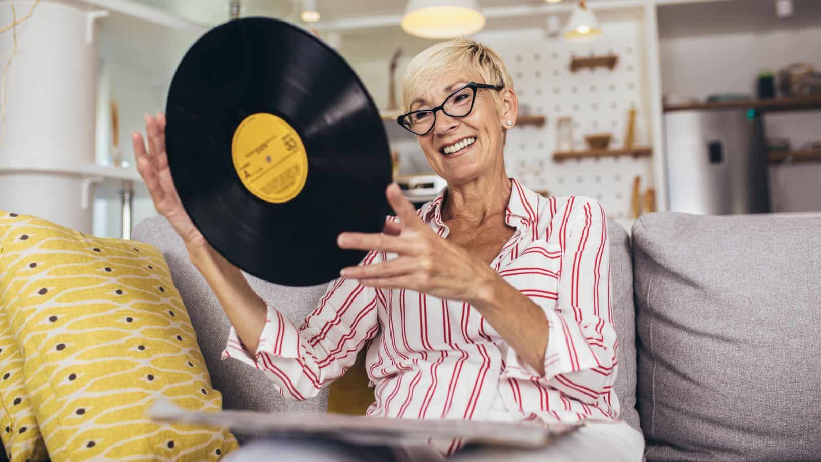 senior woman with vinyl records