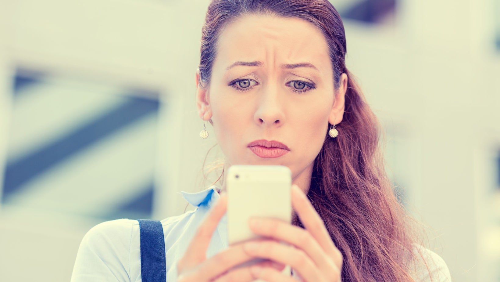 woman on phone sad, confused, shocked.