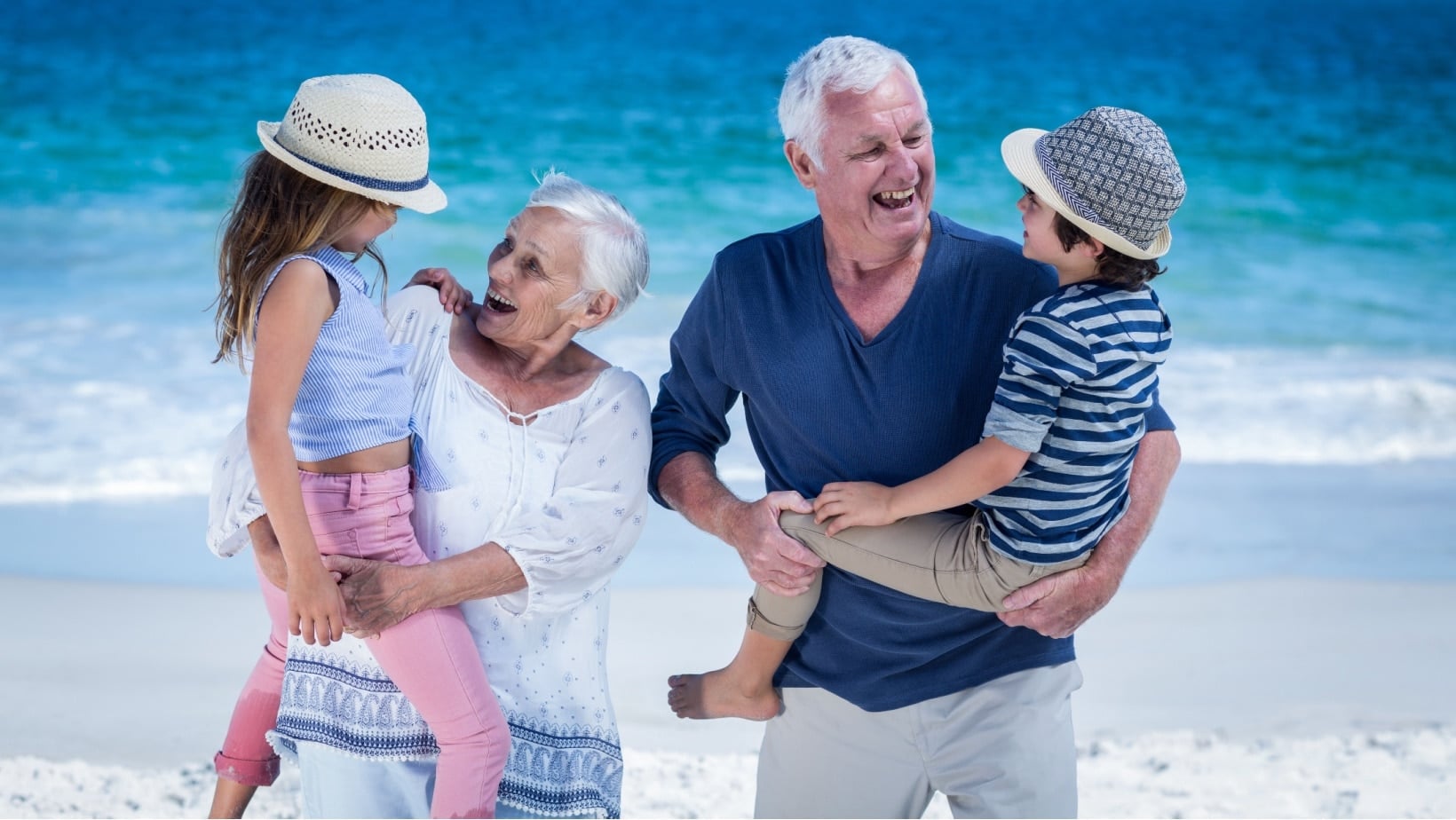 Grandparents and kids at beach. wavebreakmedia via Shutterstock.-2