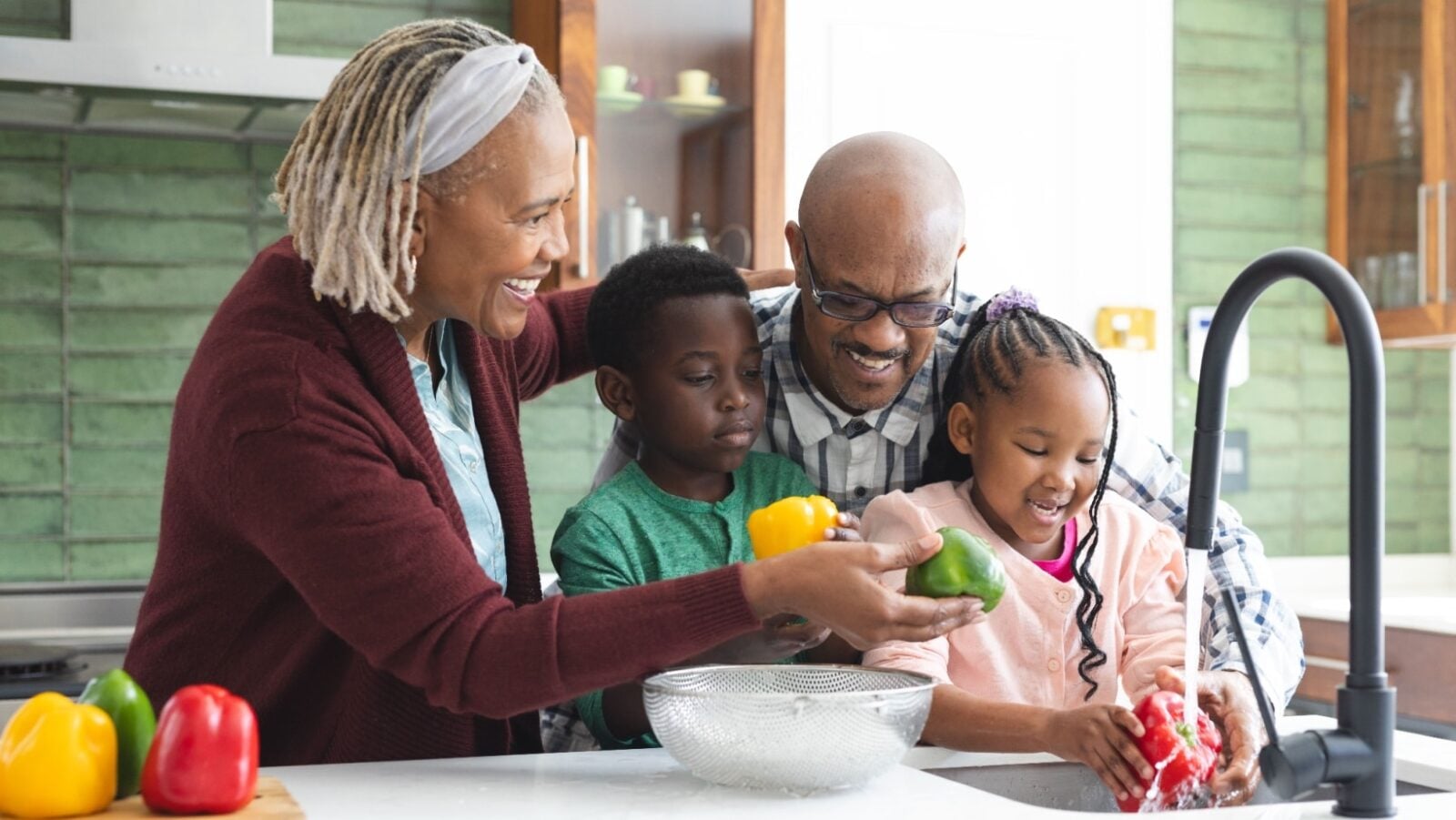 Grandparents and kids in kitchen. wavebreakmedia via Shutterstock.