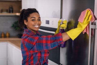 Woman cleaning refrigerator.