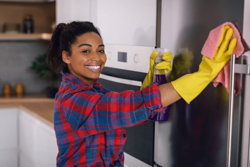 Woman cleaning refrigerator.