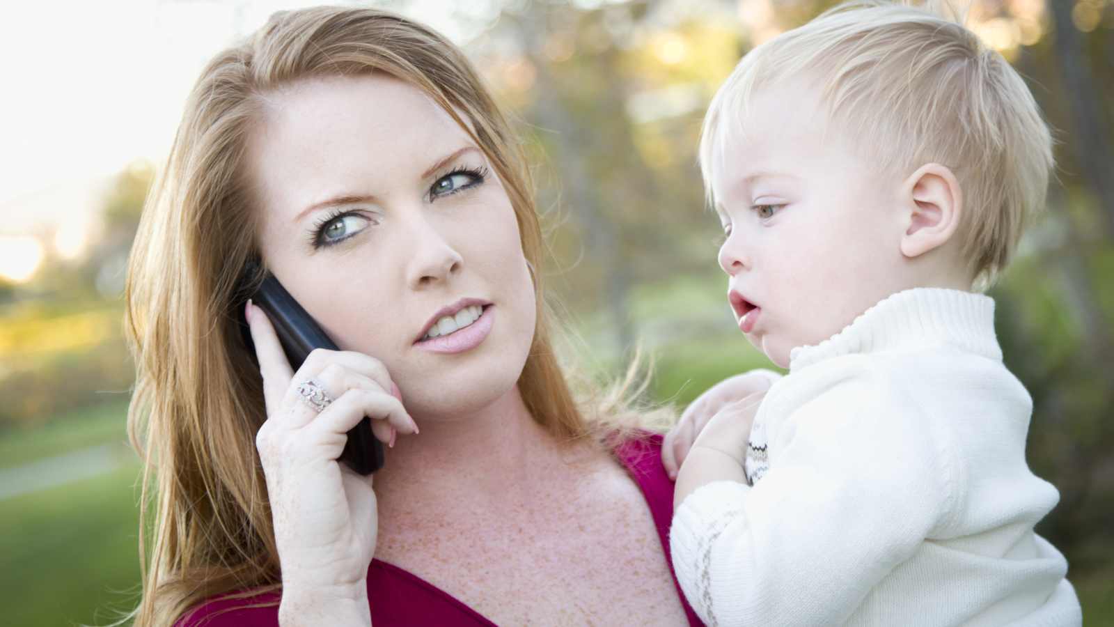 woman on phone with baby