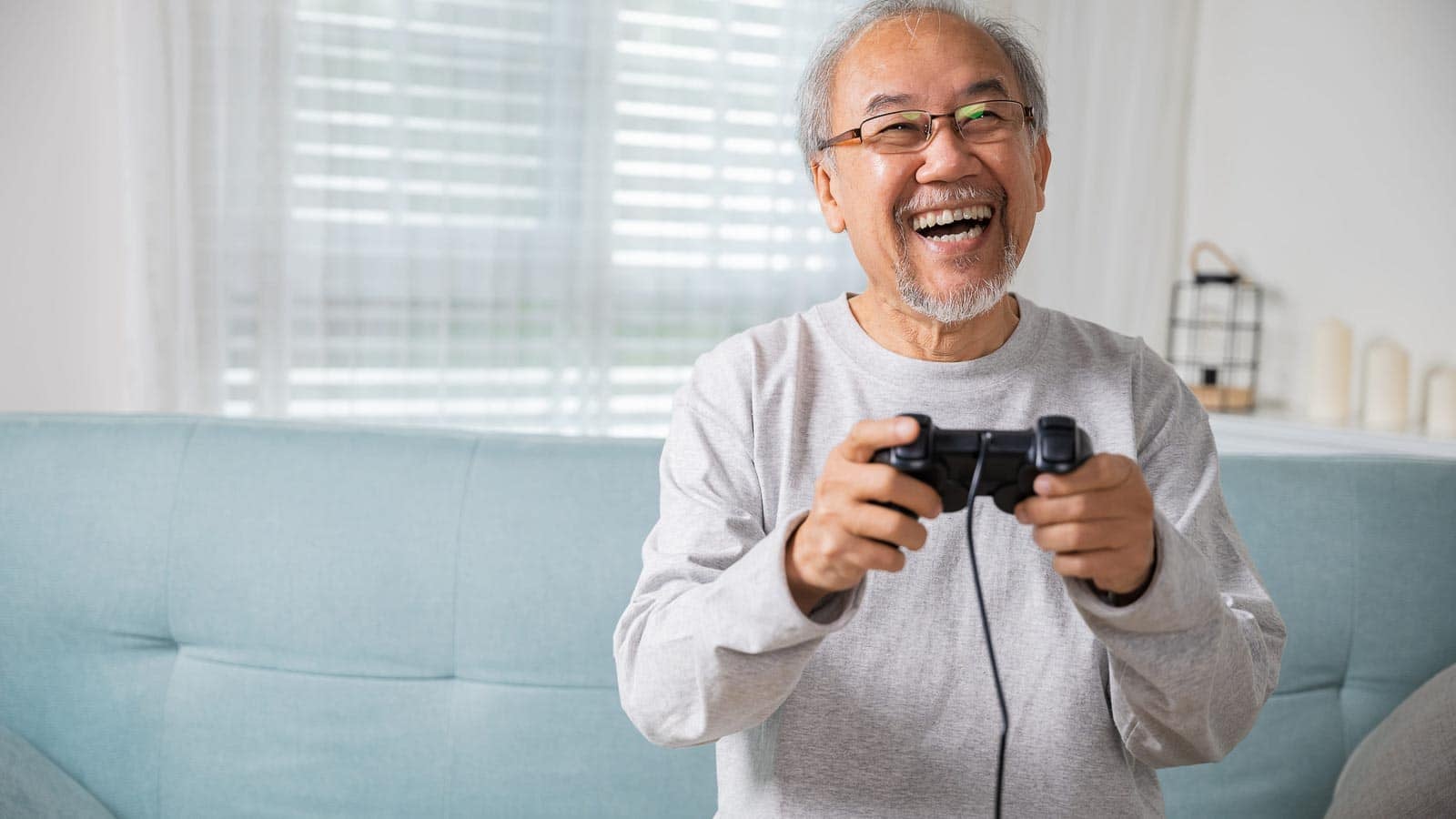 Senior playing video game. sorapop via 123rf